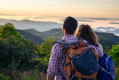 A couple enjoys a mountain vista near Asheville, NC A couple enjoys a mountain vista near Asheville, NC