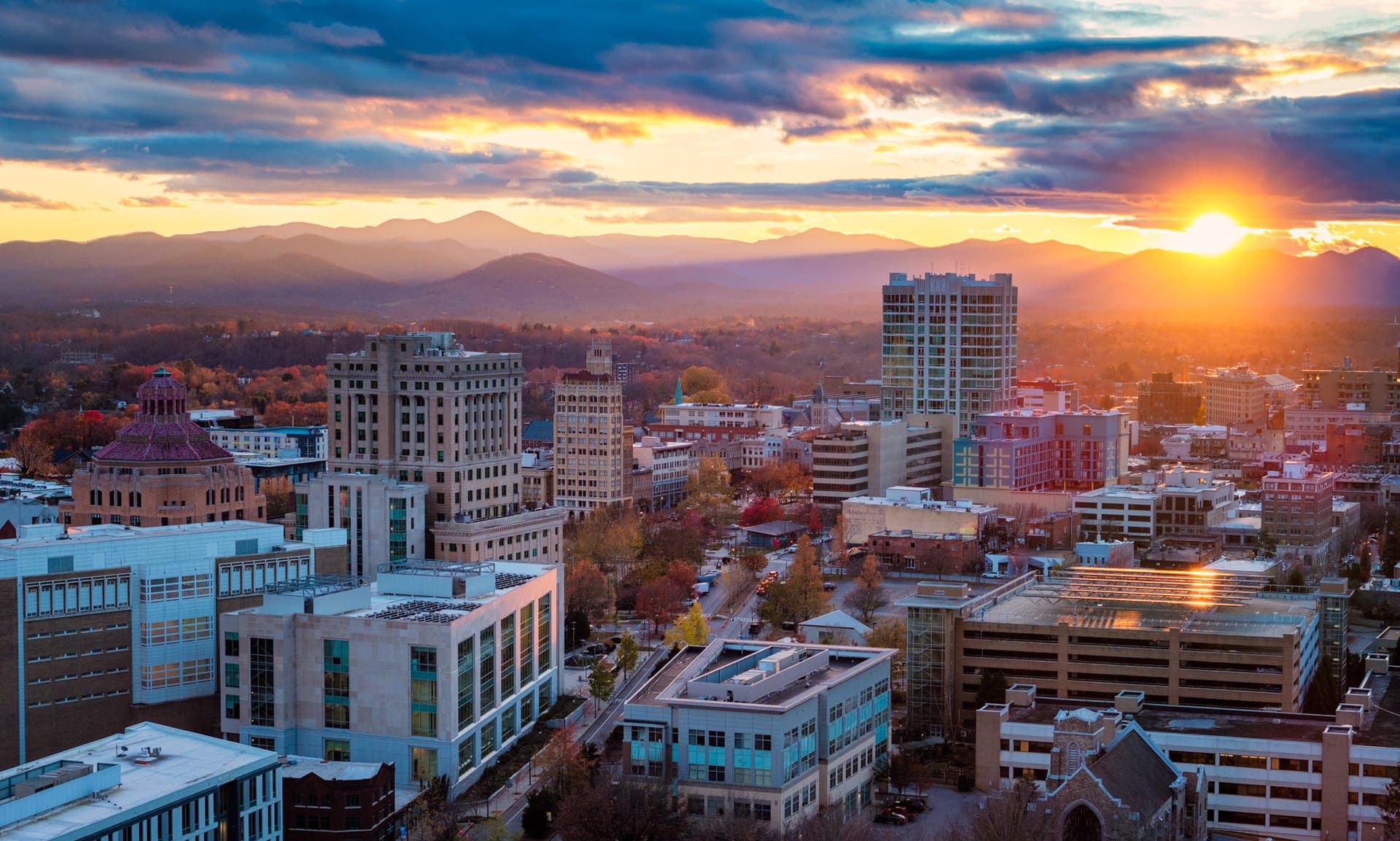 The sun rises behind downtown Asheville The sun rises behind downtown Asheville