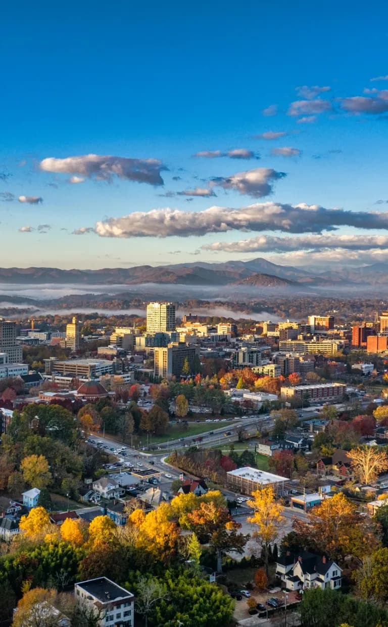 Asheville Named One of the "52 Places to Go in 2025" by The New York Times Downtown Asheville skyline / Photo: Reggie Tidwell